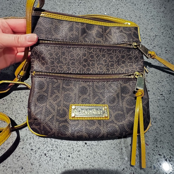 Calvin Klein Handbags - Calvin Klein Brown Monogram Crossbody with Yellow Trim